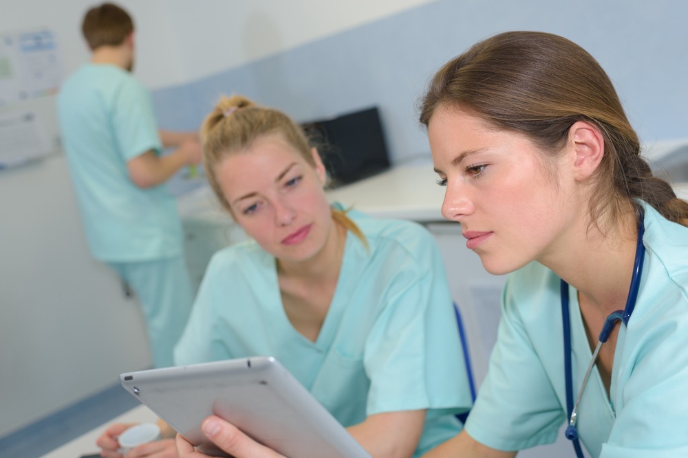 estudiantes de enfermeria miran tablet
